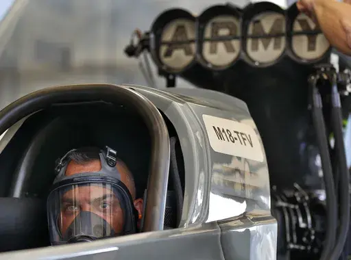 Tony Schumacher stares out from the seat of his Top Fule dragster while his crew runs tests prior to his first qualifying run of the Menards NHRA Heartland Nationals drag races Friday, May 18, 2018, at Heartland Motorsports Park in Topeka, Kan. Schumacher has a standard answer ready when drag racing fans ask when the 54-year-old three-time world champion plans to retire. Schumacher gives them the response he's used much of the past two decades: “About another 10 years.” (Chris Neal/The Capit