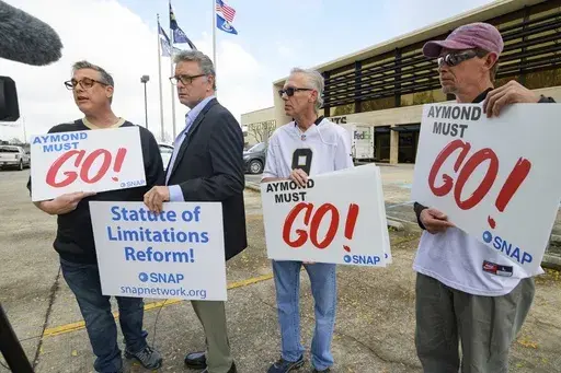 Members of SNAP, the Survivors Network of those Abused by Priests, including, from left, Kevin Bourgeois, John Gianoli, Richard Windmann and John Anderson, hold signs during a conference in front of the New Orleans Saints training facility, Jan. 29, 2020, in Metairie, La. Officially reversing a controversial March ruling, Louisiana’s highest court on Wednesday, June 12, 2024, gave childhood victims of sexual abuse a renewed opportunity to file damage lawsuits. (AP Photo/Matthew Hinton, File)