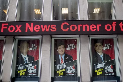 Posters of Fox News Channel personalities are displayed at the News Corp. headquarters in New York, April 19, 2017. Oregon's attorney general announced Monday, June 5, 2023, she has begun investigating the board of directors of Fox Corp., for breaching its fiduciary duties by allowing Fox News to broadcast false claims about the 2020 presidential election, claims that cost the broadcaster almost $800 million in a lawsuit. (AP Photo/Mary Altaffer, File)