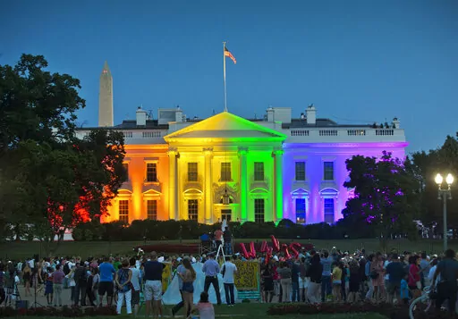People gather in Washington's Lafayette Park to see the White House illuminated with rainbow colors to mark the U.S. Supreme Court's ruling to legalize same-sex marriage, June 26, 2015. President Joe Biden plans to sign legislation this coming week that will protect gay unions even if the Supreme Court revisits its ruling supporting a nationwide right of same-sex couples to marry. It's the latest part of Biden's legacy on gay rights, which includes his unexpected endorsement of marriage equality