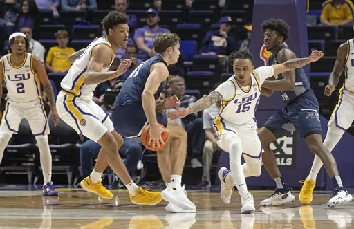 LSU forward Jalen Reed (13) and forward Tyrell Ward (15) defend against North Florida guard Nate Lliteras (11) during an NCAA college basketball game Friday, Nov. 24, 2023, in Baton Rouge, La. (Hilary Scheinuk/The Advocate via AP)