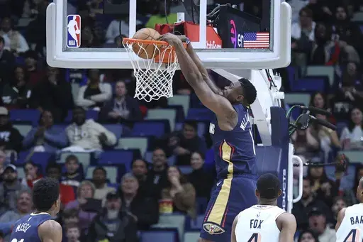 New Orleans Pelicans forward Zion Williamson (1) throws down a dunk in the first half of an NBA basketball game against the San Antonio Spurs in New Orleans, Sunday, Feb. 23, 2025. (AP Photo/Peter Forest)