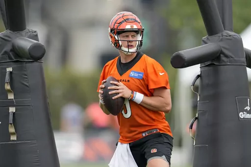 Cincinnati Bengals quarterback Joe Burrow (9) performs a drill during the NFL football team's training camp, Thursday, July 27, 2023, in Cincinnati. Burrow was back at practice on Wednesday, Aug. 30, 2023, more than a month after he was sidelined by strained right calf muscle.(AP Photo/Jeff Dean, File)
