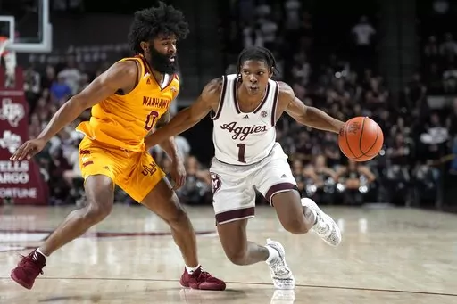 Texas A&M guard Khalen Robinson (1) drives the lane against Louisiana-Monroe guard Jamari Blackmon (0) during the second half of an NCAA college basketball game Monday, Nov. 7, 2022, in College Station, Texas. (AP Photo/Sam Craft)