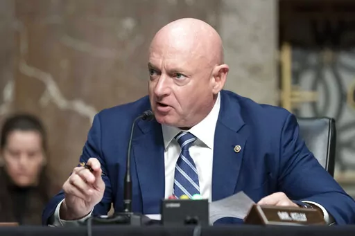 Sen. Mark Kelly, D-Ariz., speaks during a hearing of the Senate Armed Services Committee, on Capitol Hill, in Washington, March 24, 2022.  A year ago, Arizona’s Democratic Secretary of State Katie Hobbs was all over cable news, building a national profile as a defender of democracy and raking in cash for her campaign for governor. Democratic Sen. Mark Kelly, newly elected to finish John McCain’s last term and running for re-election, looked to be among the most vulnerable members of the Sena