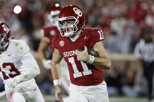 Oklahoma quarterback Jackson Arnold (11) runs the ball against Alabama during the second half of a NCAA college football game Saturday, Nov. 23, 2024, in Norman, Okla. (AP Photo/Alonzo Adams)