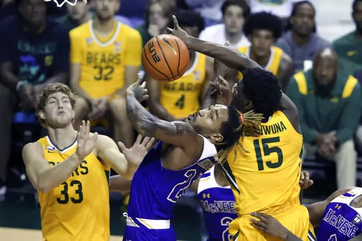 McNeese State forward Christian Shumate (24) battles Baylor forward Josh Ojianwuna (15) and Caleb Lohner (33) for control of the ball in the second half of an NCAA college basketball game, Wednesday, Nov. 23, 2022, in Waco, Texas. (AP Photo/Rod Aydelotte)