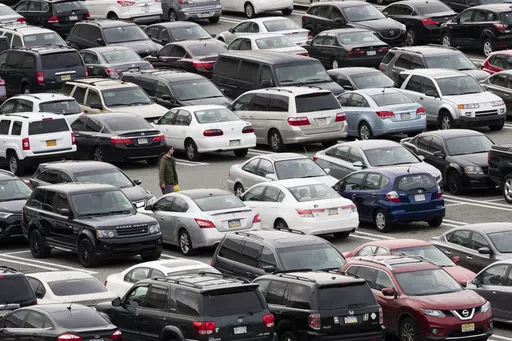 A person walks through a parking lot at a shopping mall on Dec. 8, 2016 in King of Prussia, Pa. Many newer cars use wireless key fobs and push-button starters. The technology makes it more convenient to get into your vehicle, but it also makes things easier for thieves. (AP Photo/Matt Rourke, File)