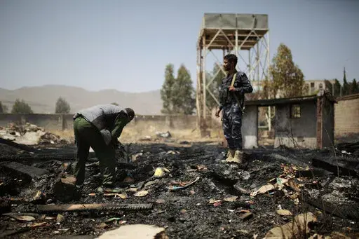 Yemeni police inspect a site of Saudi-led airstrikes targeting two houses in Sanaa, Yemen, Saturday, March 26, 2022.   Yemen's warring sides have accepted a two-month truce, starting with the Muslim holy month of Ramadan, the U.N. envoy to Yemen said Friday, April 1.  The envoy, Hans Grundberg, announced the agreement from Amman, Jordan, after meeting separately with both sides in the country's brutal civil war in recent days. He said that he hoped the truce would be renewed after two months. (A