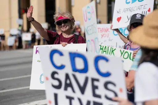 Lynn Sokler, who retired from the CDC three weeks ago after working there almost two decades, protests with others in support of the Centers for Disease Control and Prevention in front of the headquarters in Atlanta, on Tuesday, April 1, 2025. (AP Photo/Ben Gray)