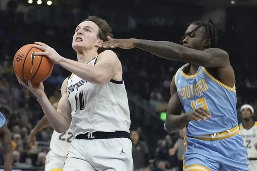 Marquette's Tyler Kolek drives past Southern's Dre'Shawn Allen during the first half of an NCAA college basketball game Tuesday, Nov. 28, 2023, in Milwaukee. (AP Photo/Morry Gash)