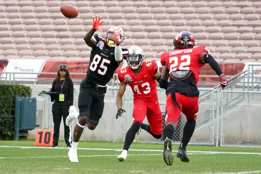 American Team wide receiver Dai'Jean Dixon (85) catches a touchdown pass against the National Team during the first half of the NFLPA Collegiate Bowl college football game Saturday, Jan. 29, 2022, in Pasadena, Calif. (AP Photo/Marcio Jose Sanchez)