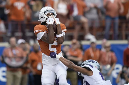 Texas wide receiver Adonai Mitchell (5) makes a touchdown catch over Kansas State cornerback Jacob Parrish (10) during the first half of an NCAA college football game in Austin, Texas, Saturday, Nov. 4, 2023. Mitchell was selected as the Big 12 newcomer of the year. (AP Photo/Eric Gay, File)