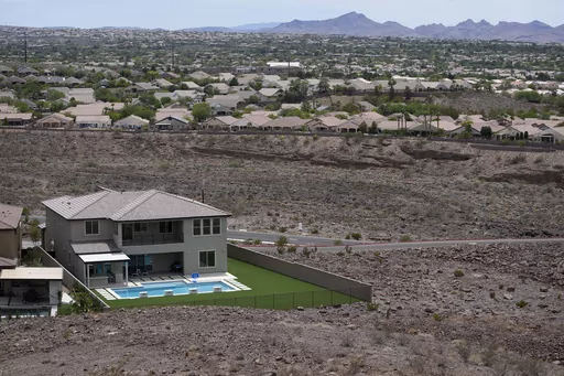 A home with a swimming pool abuts the desert on the edge of the Las Vegas valley July 20, 2022, in Henderson, Nev. Nevada lawmakers on Monday, March 13, 2023, will consider another shift in water use for one of the driest major metropolitan areas in the U.S. The water agency that manages the Colorado River supply for Vegas is seeking authority to limit what comes out of residents' taps. (AP Photo/John Locher, File)