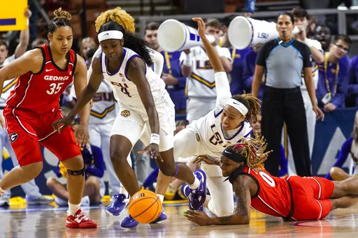 LSU's Flau'jae Johnson (4) dribbles in front of Georgia's Javyn Nicholson (35) in the first half of an NCAA college basketball game during the Southeastern Conference women's tournament in Greenville, S.C., Friday, March 3, 2023. (AP Photo/Mic Smith)
