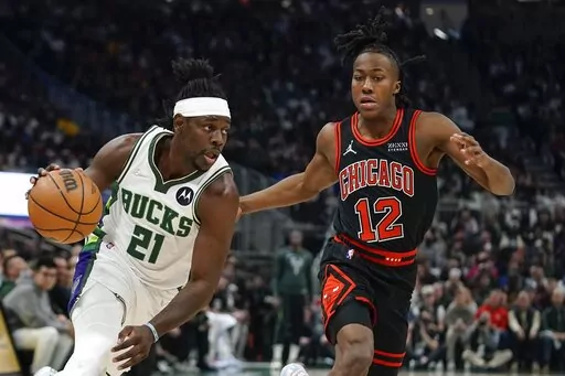 Milwaukee Bucks' Jrue Holiday drives past Chicago Bulls' Ayo Dosunmu during the first half of Game 1 of their first round NBA playoff basketball game Sunday, April 17, 2022, in Milwaukee. (AP Photo/Morry Gash)