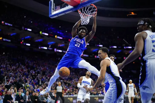 Philadelphia 76ers' Joel Embiid (21) dunks during the first half of an NBA basketball game against the Orlando Magic, Wednesday, Feb. 1, 2023, in Philadelphia. (AP Photo/Matt Slocum)