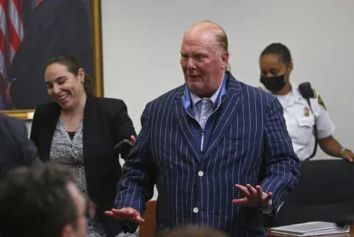 Celebrity chef Mario Batali reacts after being found not guilty of indecent assault and battery at Boston Municipal Court on the second day of his trial, on Tuesday, May 10, 2022 in Boston.  Batali, who pleaded not guilty to indecent assault and battery in 2019, had faced up to 2 1/2 years in jail and would’ve been required to register as a sex offender if convicted.  (Stuart Cahill/The Boston Herald via AP, Pool)