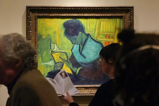 Visitors file past at the Van Gogh painting "Une Liseuse De Romans", also known as "The Novel Reader", during the Van Gogh in America exhibit at the Detroit Institute of Arts, Wednesday, Jan. 11, 2023, in Detroit. (Andy Morrison/Detroit News via AP)