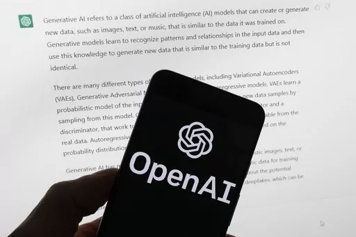 The OpenAI logo is seen on a mobile phone in front of a computer screen displaying output from ChatGPT, Tuesday, March 21, 2023, in Boston. Are tech companies moving too fast in rolling out powerful artificial intelligence technology that could one day outsmart humans? That is the conclusion of a group of prominent computer scientists and other tech industry notables who are calling for a 6-month pause to consider the risks. Their petition published Wednesday, March 29, 2023, is a response to Sa