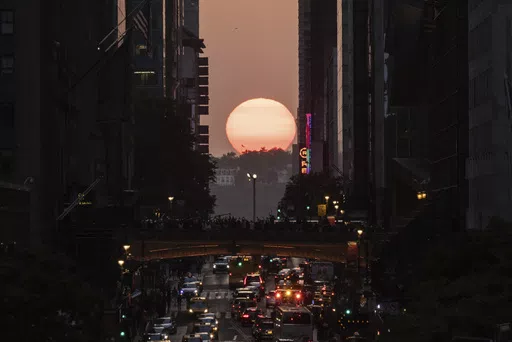 The sun sets between buildings along 42nd Street in New York during a phenomenon known as "Manhattanhenge," May 30, 2023. Twice per year, New Yorkers and visitors are treated to a phenomenon known as Manhattanhenge, when the setting sun aligns with the Manhattan street grid and sinks below the horizon framed in a canyon of skyscrapers. Manhattanhenge happens for the first time this year on Tuesday, May 28, at 8:13 p.m. and Wednesday, May 29, at 8:12 p.m. (AP Photo/Yuki Iwamura, File)