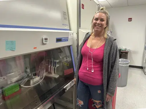 Kelsie Lynn Becklin, 38, of New Brighton, Minn., who learned on Wednesday, Dec. 11, 2024, that she was pardoned by President Joe Biden, is shown in a student lounge in the Molecular and Cellular Biology Building at the University of Minnesota in Minneapolis on Friday. Dec. 13, 2024. (AP Photo/Steve Karnowski)