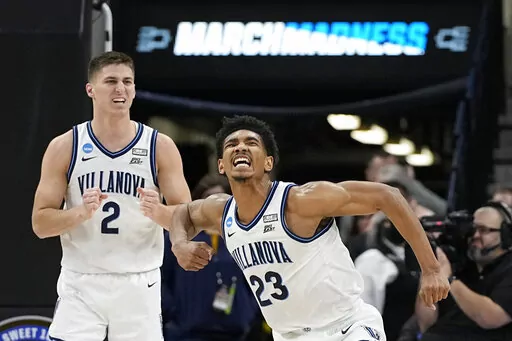 Villanova forward Jermaine Samuels celebrates after scoring with guard Collin Gillespie during the second half of a college basketball game against Michigan in the Sweet 16 round of the NCAA tournament on Thursday, March 24, 2022, in San Antonio. (AP Photo/David J. Phillip)