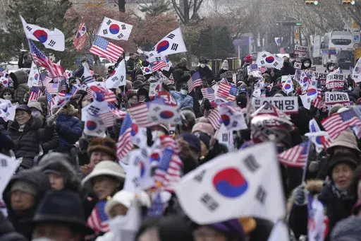 Supporters of impeached South Korean President Yoon Suk Yeol shout slogans during a rally to oppose his impeachment near the Constitutional Court in Seoul, South Korea, Tuesday, Jan. 14, 2025. (AP Photo/Lee Jin-man)