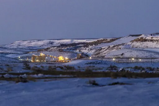 Lights illuminate a coal mine at twilight, Jan. 13, 2022, in Kemmerer, Wyo. With the nearby coal-fired Naughton Powerplant being decommissioned in 2025, the fate of the coal mine and its workers is uncertain. More than 500 days into his presidency, Joe Biden's hope for saving the Earth from the most devastating effects of climate change may not be dead. But it's not far from it after a Supreme Court ruling not only limited the Environmental Protection Agency's ability to regulate pollution by po