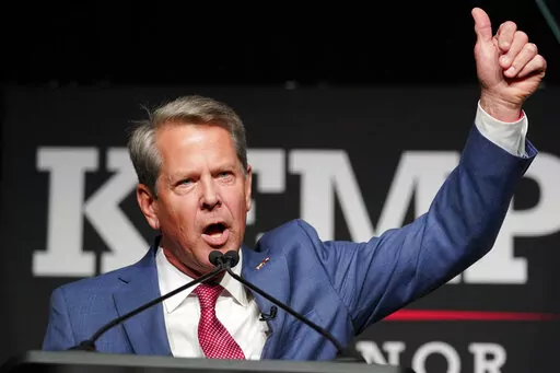 Republican Gov. Brian Kemp waves to supporters during an election night watch party, Tuesday, May 24, 2022, in Atlanta. Kemp easily turned back a GOP primary challenge Tuesday from former U.S. Sen. David Perdue, who was backed by former President Donald Trump. (AP Photo/John Bazemore)