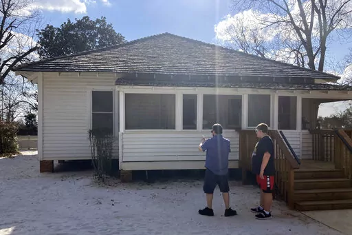 Chad Loshbaugh, 51, of Albany, New York, and his son diverted their vacation plans, Wednesday, Feb. 22, 2023, to visit former President Jimmy Carter's boyhood farm in the Archery community just outside Plains, Ga., the 39th president's hometown. Carter, 98, is at home in Plains receiving end-of-life care. The announcement that he's entered hospice has attracted new visitors to Plains and Carter's presidential library and museum in Atlanta and drawn well-wishes and praise from across the globe. (