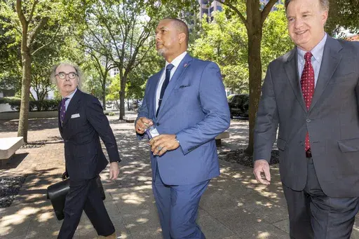 New Orleans Mayor LaToya Cantrell's former bodyguard and policeman, Jeffrey Vappie, center, walks to federal court in downtown New Orleans with his attorneys, Harry Rosenberg, left, and Shaun Clarke, right, Wednesday, Aug. 7, 2024. (Chris Granger/The Times-Picayune/The New Orleans Advocate via AP, File)