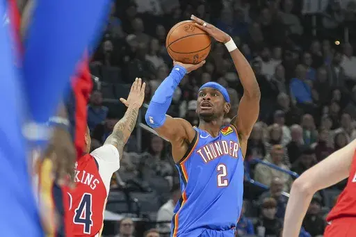 Oklahoma City Thunder guard Shai Gilgeous-Alexander (2) shoots over New Orleans Pelicans guard Jordan Hawkins, left, during the first half of an NBA basketball game, Monday, Feb. 10, 2025, in Oklahoma City. (AP Photo/Kyle Phillips)