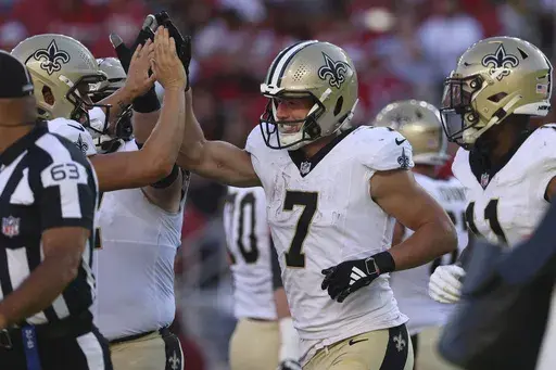 New Orleans Saints' Taysom Hill (7) is congratulated by teammates after scoring against the San Francisco 49ers during the first half of a preseason NFL football game in Santa Clara, Calif., Sunday, Aug. 18, 2024. (AP Photo/Jed Jacobsohn)