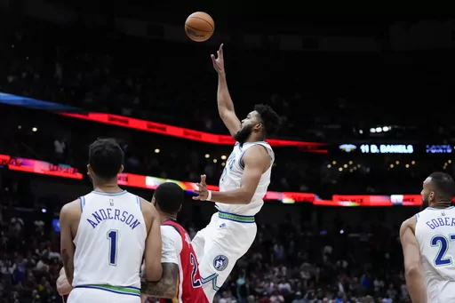 Minnesota Timberwolves center Karl-Anthony Towns (32) shoots the game-winning basket with 5.2 seconds remaining on the clock in the second half of an NBA basketball game against the New Orleans Pelicans in New Orleans, Saturday, Nov. 18, 2023. The Timberwolves won 121-120. (AP Photo/Gerald Herbert)