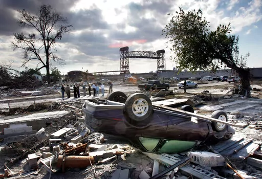 Members of the Louisiana Recovery Authority tour New Orleans' hurricane-ravaged Lower 9th Ward, Wednesday, Oct. 26, 2005, as much of the 9th Ward was destroyed when the levee broke at the Industrial Canal during Hurricanes Katrina and Rita. Seventeen years after Hurricane Katrina flooded New Orleans, the Army Corps of Engineers has completed an extensive system of floodgates, strengthened levees and other protections. (AP Photo/Robert F. Bukaty, File)
