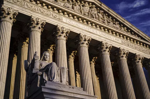 The Supreme Court is seen at dusk in Washington on Oct. 22, 2021. The Supreme Court is hearing a case its conservative majority could use to hobble Biden administration efforts to combat climate change. In arguments Monday, Feb. 28, 2022, justices are taking up an appeal from 19 mostly Republican-led states and coal companies over the Environmental Protection Agency's authority to limit carbon dioxide emissions from power plants. (AP Photo/J. Scott Applewhite, File)