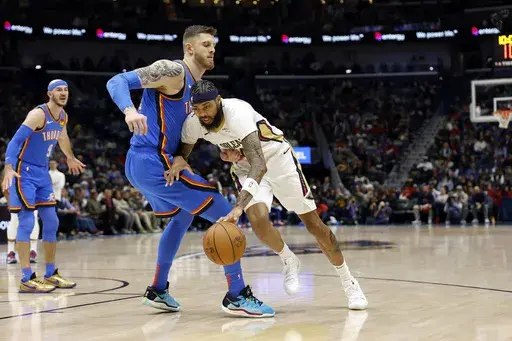 New Orleans Pelicans forward Brandon Ingram (14) drives to the basket as Oklahoma City Thunder center Isaiah Hartenstein (55) defends in the first half of an NBA basketball game in New Orleans, Saturday, Dec. 7, 2024. (AP Photo/Tyler Kaufman)