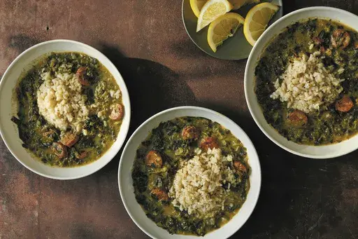 This image released by Simon Element shows a recipe for green spring gumbo with chicken andouille, from the cookbook "Eat Better, Sleep Better: 75 Recipes and A 28-Day Meal Plan That Unlock the Food-Sleep Connection" by Dr Marie-Pierre St-Onge and Kat Craddock. (David Malosh/Simon Element via AP)