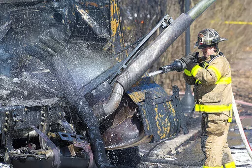 Firefighers work the scene after a tanker truck overturned on U.S. 15 in Frederick, Md., on Saturday, March 4, 2023. The fiery crash killed the driver and burned vehicles and homes in Frederick, about an hour's drive west of Baltimore, authorities said. (Bill Green /The Frederick News-Post via AP)