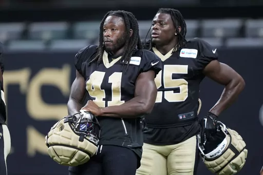 New Orleans Saints running backs Alvin Kamara (41) and Kendre Miller (25) go through drills at the NFL team's football training camp in the Caesars Superdome in New Orleans, Friday, Aug. 11, 2023. (AP Photo/Gerald Herbert)