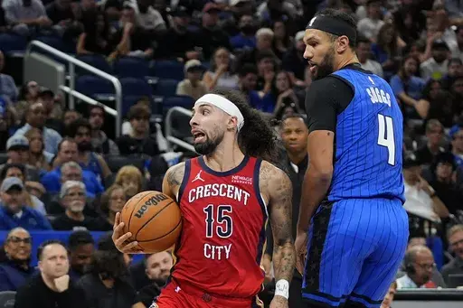 New Orleans Pelicans guard Jose Alvarado (15) looks to pass the ball as he gets around Orlando Magic guard Jalen Suggs (4) during the second half of an NBA basketball game, Friday, Nov. 8, 2024, in Orlando, Fla. (AP Photo/John Raoux)