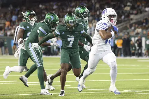 Memphis running back Greg Desrosiers Jr., right, takes a reception into the end zone against Tulane defenders during the first half of an NCAA college football game in New Orleans, Thursday, Nov. 28, 2024. (AP Photo/Peter Forest)