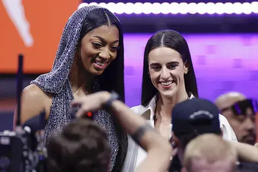 LSU's Angel Reese, left, and Iowa's Caitlin Clark, right, pose for a photo before the WNBA basketball draft, Monday, April 15, 2024, in New York. Caitlin Clark and Angel Reese will once again step into the spotlight during All-Star Weekend with their matchup against Team USA. (AP Photo/Adam Hunger, File)