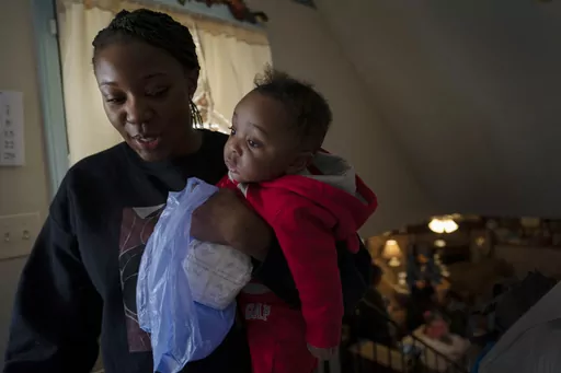 Ansonia Lyons carries her son, Adrien Lyons, as she takes him for a diaper change in Birmingham, Ala., on Saturday, Feb. 5, 2022. After two miscarriages, Ansonia became pregnant in 2020, and it was difficult. Doctors initially told her she was suffering from regular morning sickness, though she was vomiting blood. Ultimately, she was diagnosed with an excessive vomiting disorder. A study published Monday, July 3, 2023, in the Journal of the American Medical Association shows maternal mortality r