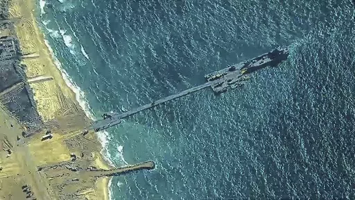 The image provided by U.S, Central Command, shows U.S. Army soldiers assigned to the 7th Transportation Brigade (Expeditionary), U.S. Navy sailors assigned to Amphibious Construction Battalion 1, and Israel Defense Forces placing the Trident Pier on the coast of Gaza Strip on Thursday, May 16, 2024. The temporary pier is part of the Joint Logistics Over-the-Shore capability. The U.S. military finished installing the floating pier on Thursday, with officials poised to begin ferrying badly needed 