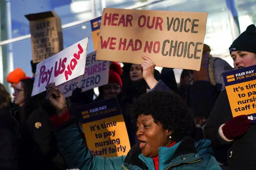 Nurses hold banners and placards as they picket during a strike over pay, outside the University College Hospital, in London, Wednesday, Jan. 18, 2023.(AP Photo/Alberto Pezzali)
