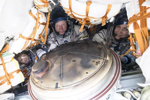 NASA's Loral O'Hara, left, Russia’s Oleg Novitsky and Belarus spaceflight participant Marina Vasilevskaya, right, are seen inside the Soyuz MS-24 spacecraft after they landed in a remote area near the town of Dzhezkazgan, Kazakhstan, Saturday, April 6, 2024. (Bill Ingalls/NASA via AP)