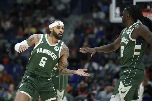 Milwaukee Bucks guard Gary Trent Jr. (5) celebrates after a basket with forward Taurean Prince (12) during the first half of an NBA basketball game against the New Orleans Pelicans in New Orleans, Sunday, April 6, 2025. (AP Photo/Matthew Hinton)