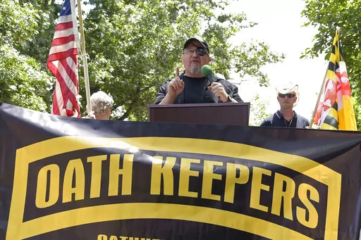Stewart Rhodes, founder of the Oath Keepers, center, speaks during a rally outside the White House in Washington, June 25, 2017. Hundreds of pages of court documents in the case against Rhodes and four co-defendants, whose trial opens with jury selection Tuesday, Sept. 27, 2022, in Washington's federal court, paint a picture of a group so determined to overturn Biden's election that some members were prepared to lose their lives to do so. (AP Photo/Susan Walsh, File)